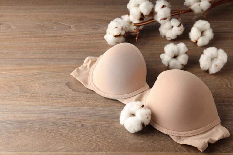 Concept of women's clothes with underwear on wooden background